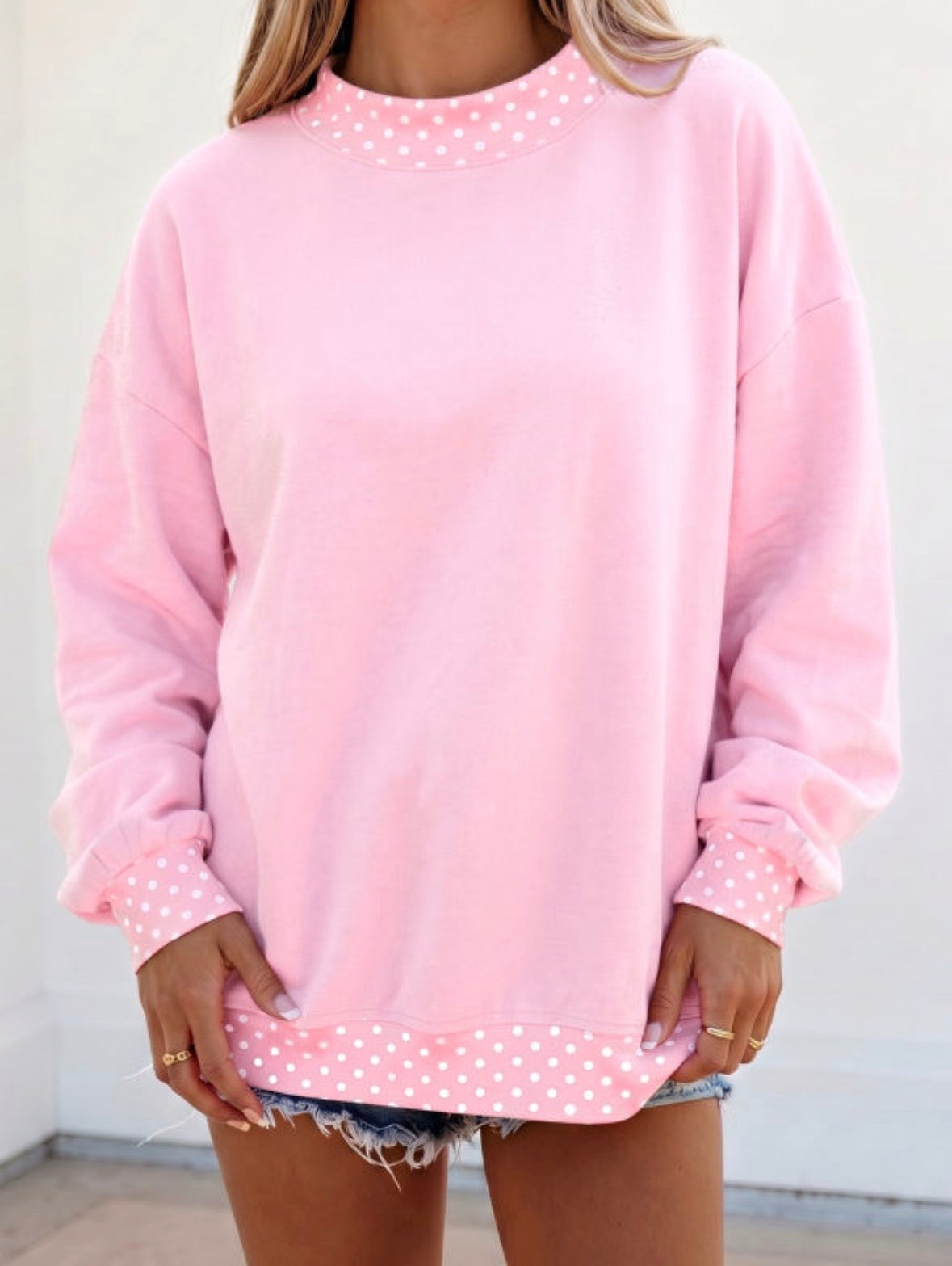 Pink sweatshirt with polka dot cuffs